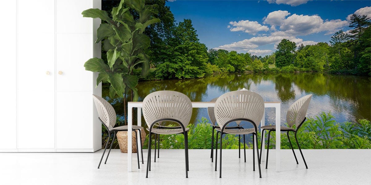 Tranquil Lakeside Escape mural with lush greenery, dining chairs, white flooring, white table, open room.