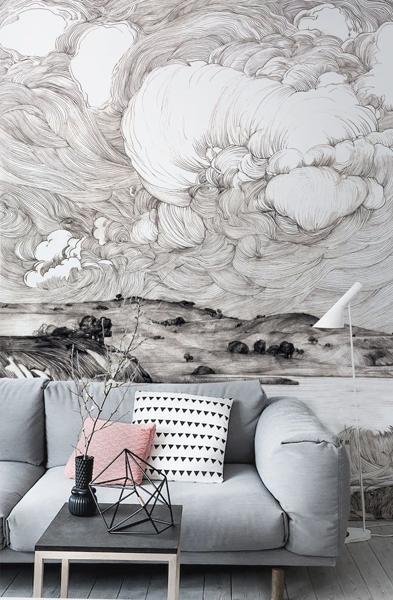 Monochrome coastal mural wallpaper with artistic waves, grey sofa, light wood flooring, and modern decor.