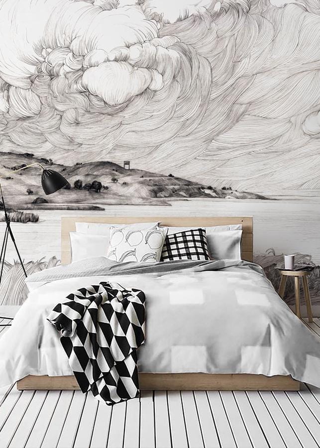 Monochrome coastal mural wallpaper in bedroom, artistic waves design, white bedding, wooden bed, striped floor.