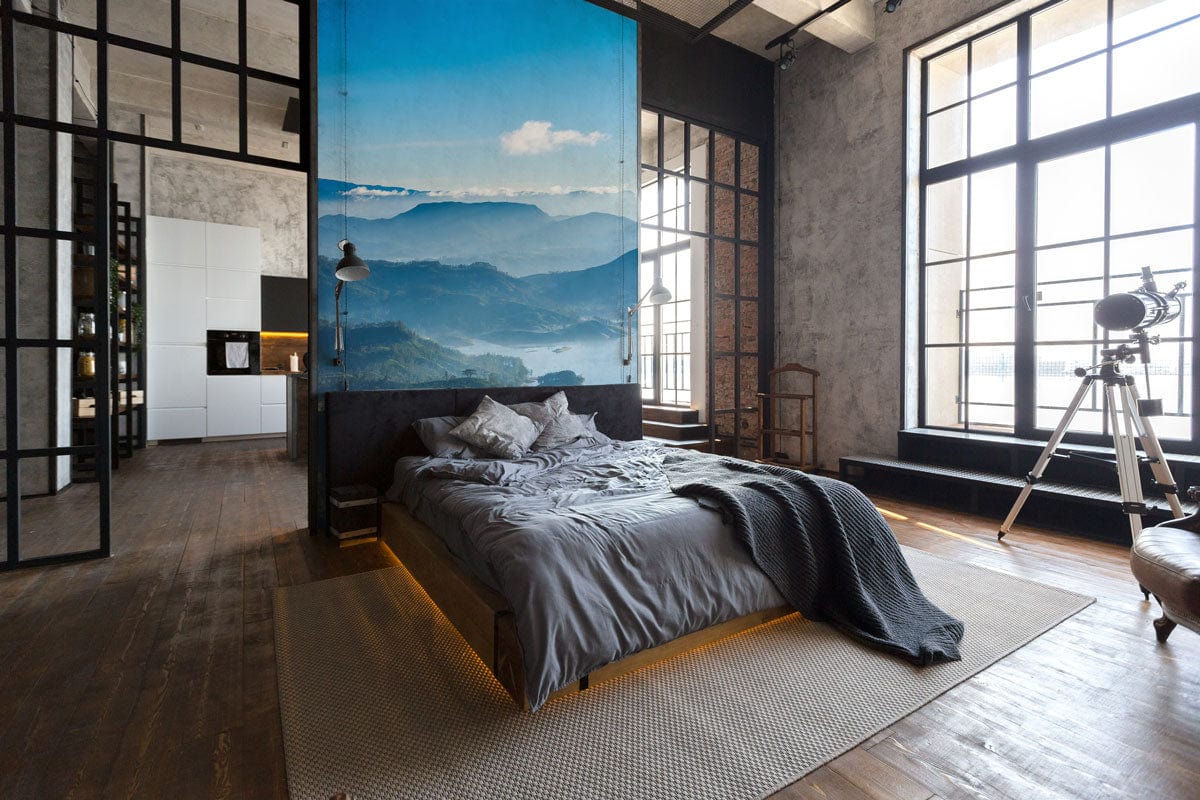 Luxurious bedroom with Serene Blue Misty Mountain mural, grey bedding, wooden flooring, modern decor.