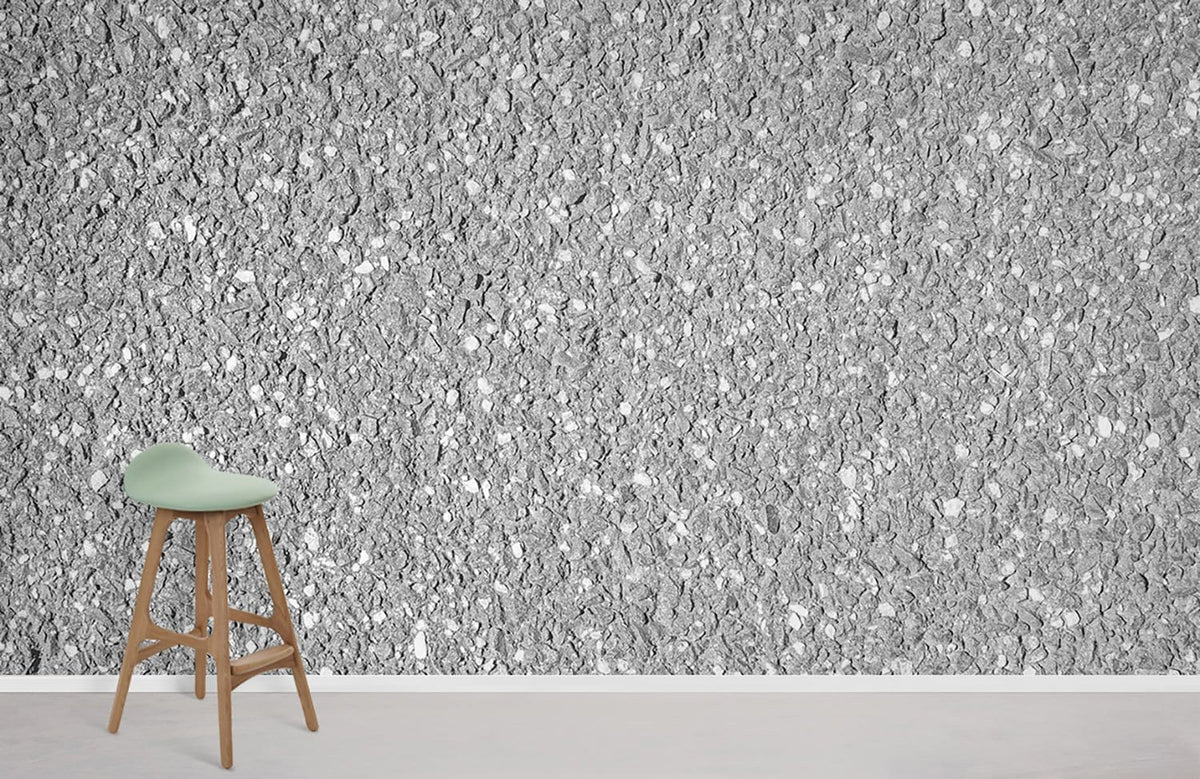 Elegant grey granite stone effect wallpaper with light wood stool, ideal for modern interior design.