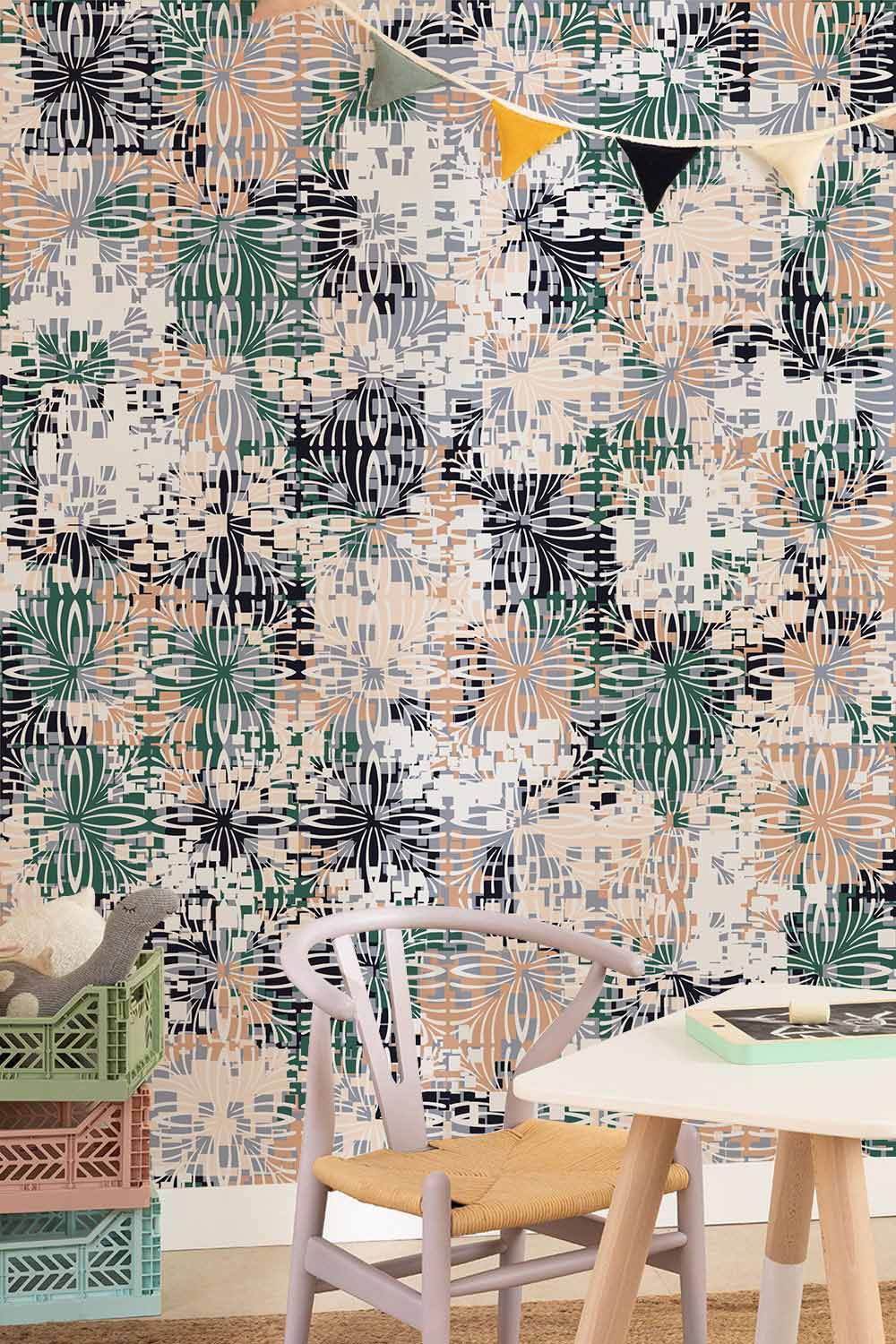 Abstract floral leaf pattern wallpaper in green, orange, black tones; modern chair, colourful storage boxes.