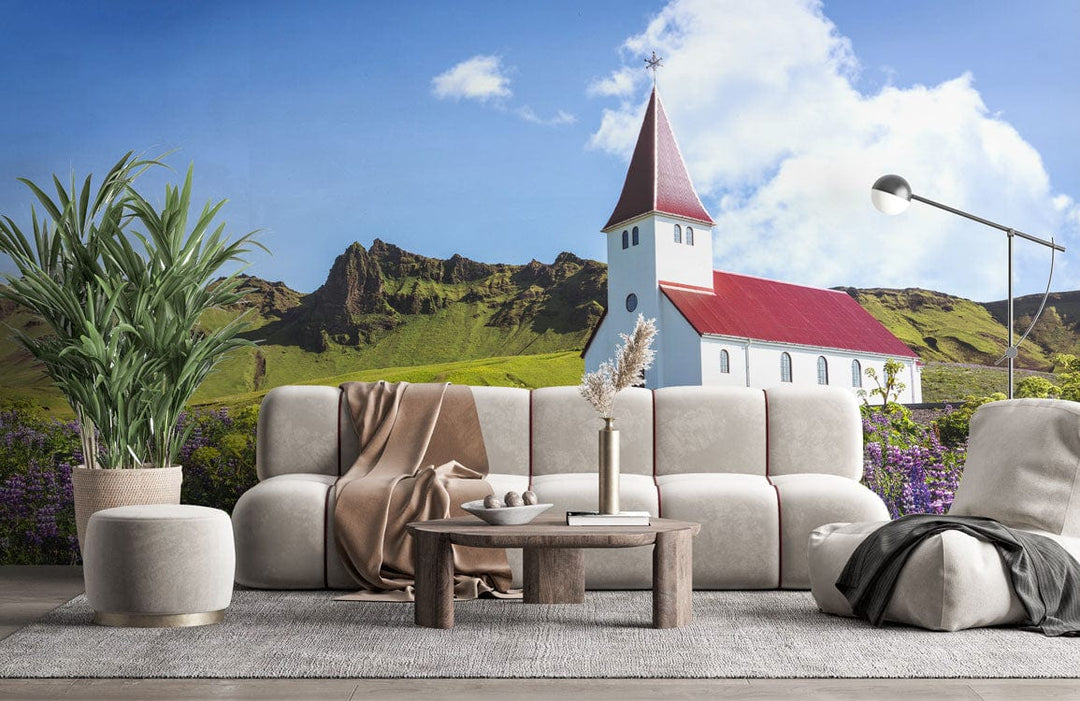 Idyllic countryside church mural wallpaper with wildflowers, cream sofa, wooden table, grey rug in lounge.