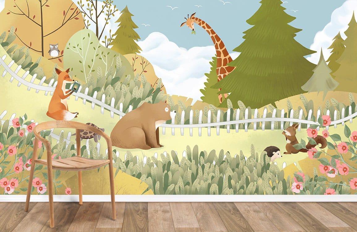 Whimsical woodland animals mural wallpaper with giraffe and bear scene, wooden chair, and wood flooring.