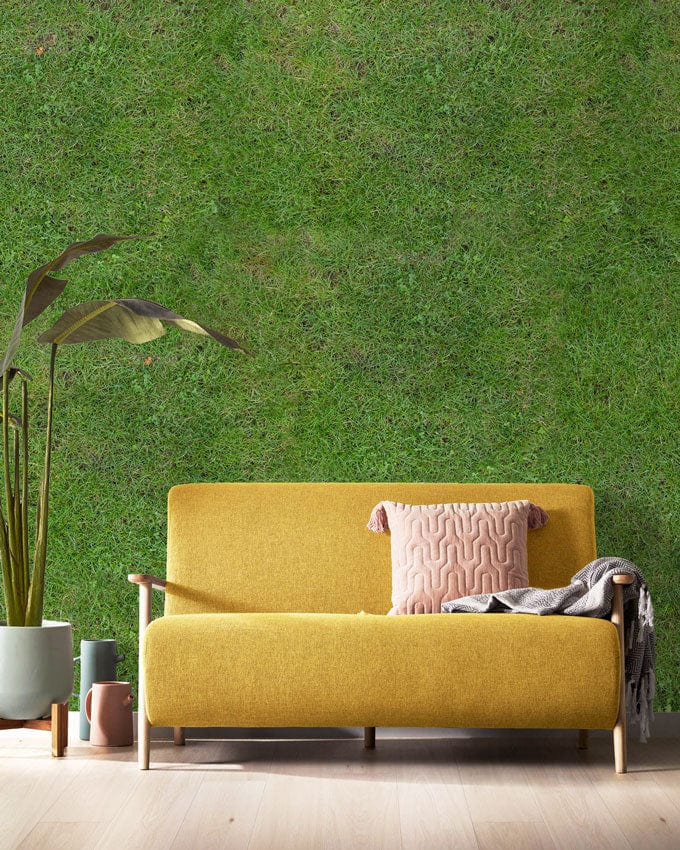 Yellow sofa against Natural Green Grass Texture Mural Wallpaper, light wooden flooring, creating serene ambiance.
