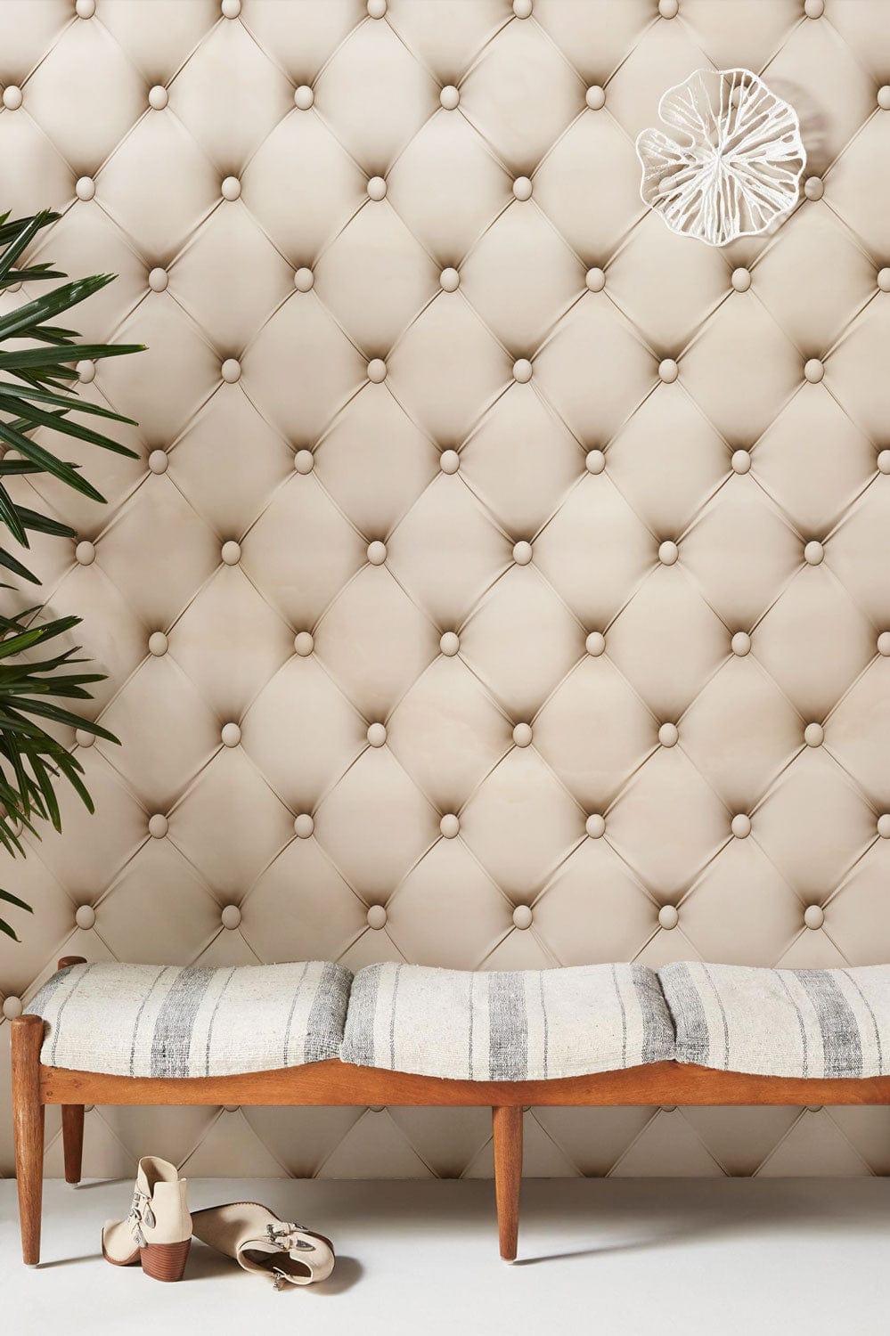 Luxurious cream quilted wallpaper with elegant bench, shoes, plant; perfect for sophisticated interiors.