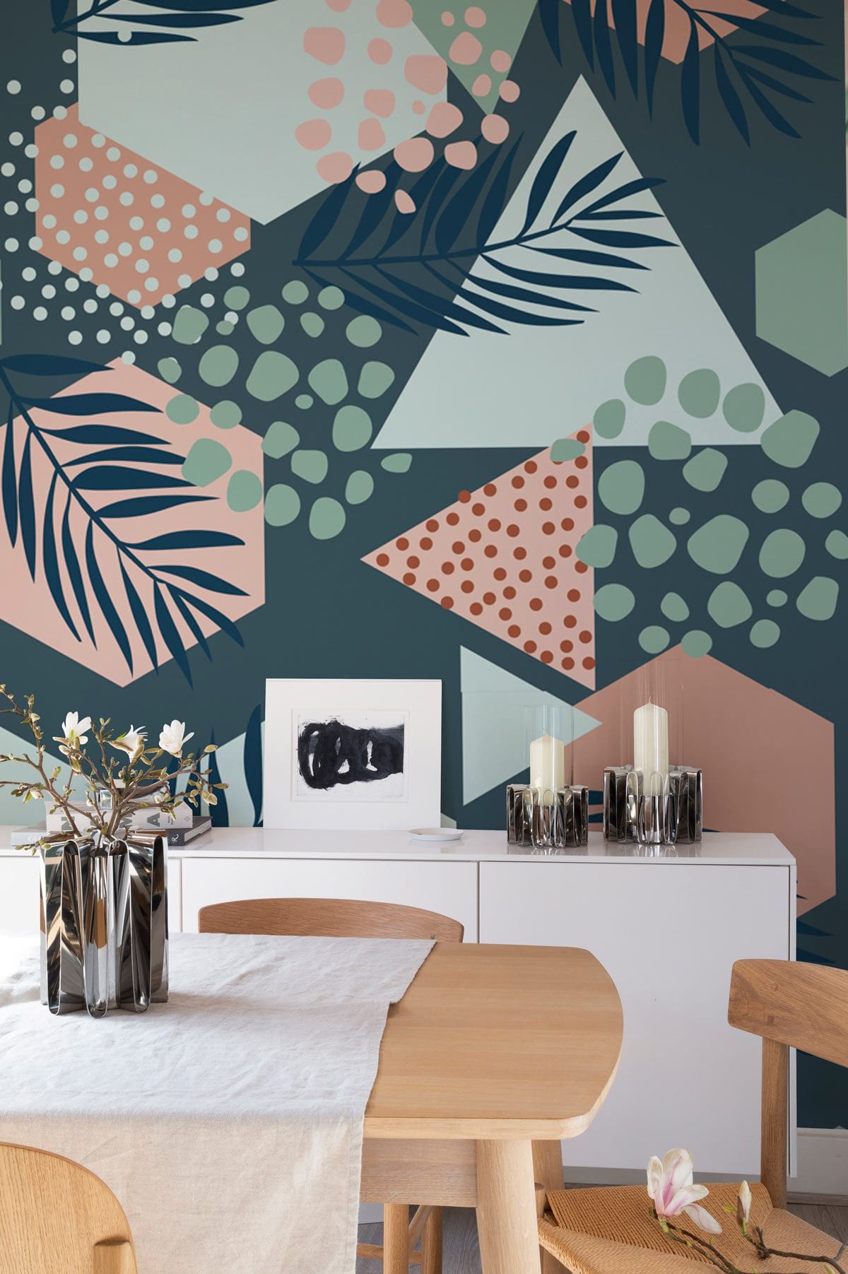 Geometric Leaf Wallpaper in Pastels, Navy Tones, minimalist dining room, light wood table, white sideboard.