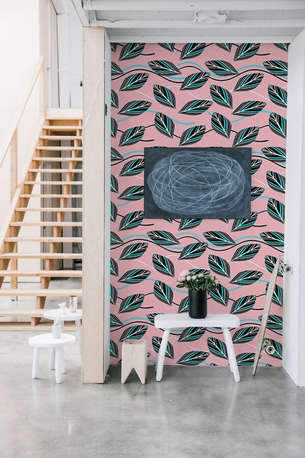 Art Deco Leaves blush pink teal wallpaper, elegant hallway, modern concrete flooring, wooden stairs, white bench.
