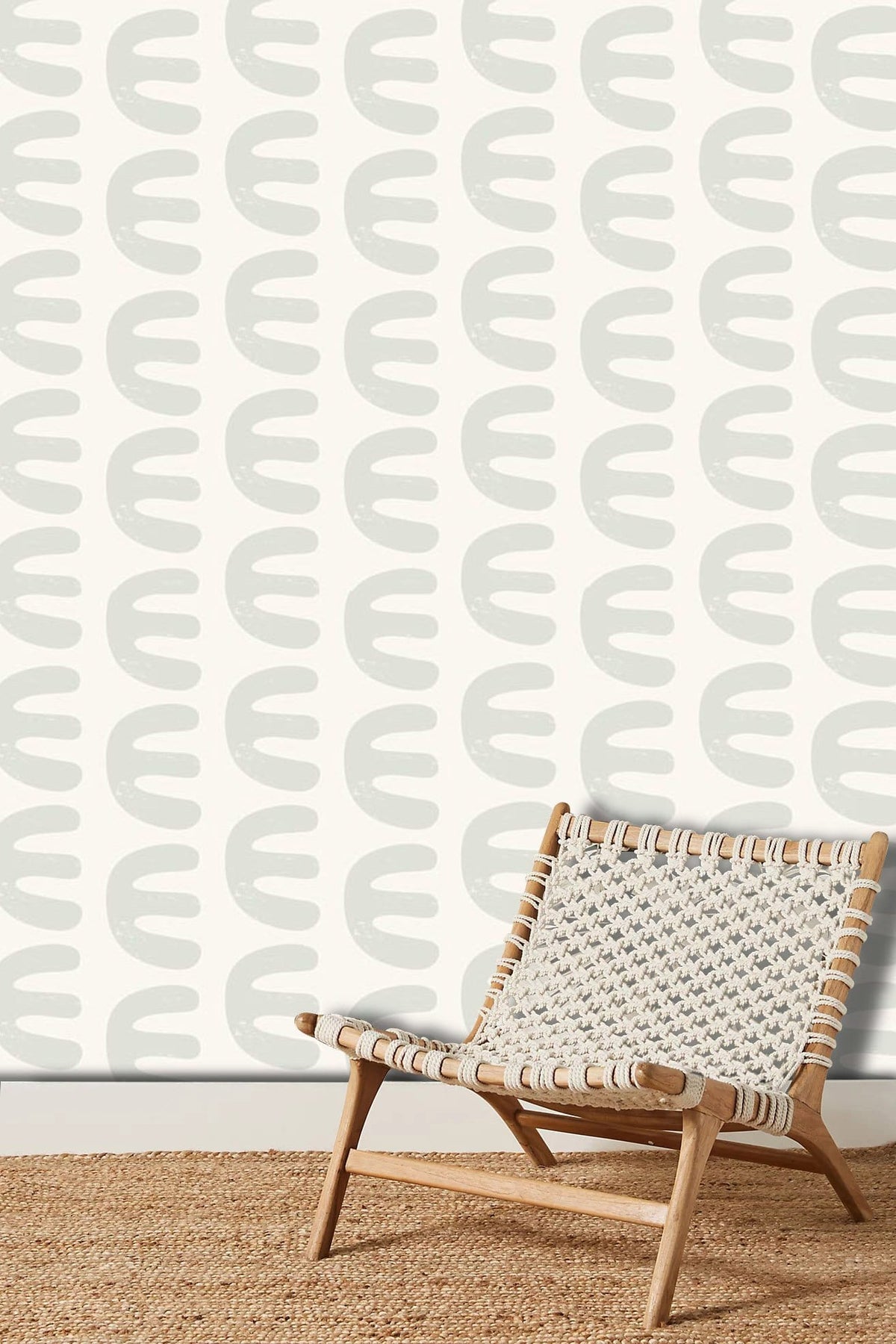 Elegant cream retro wallpaper with chair on woven rug in a minimalist vintage living room.