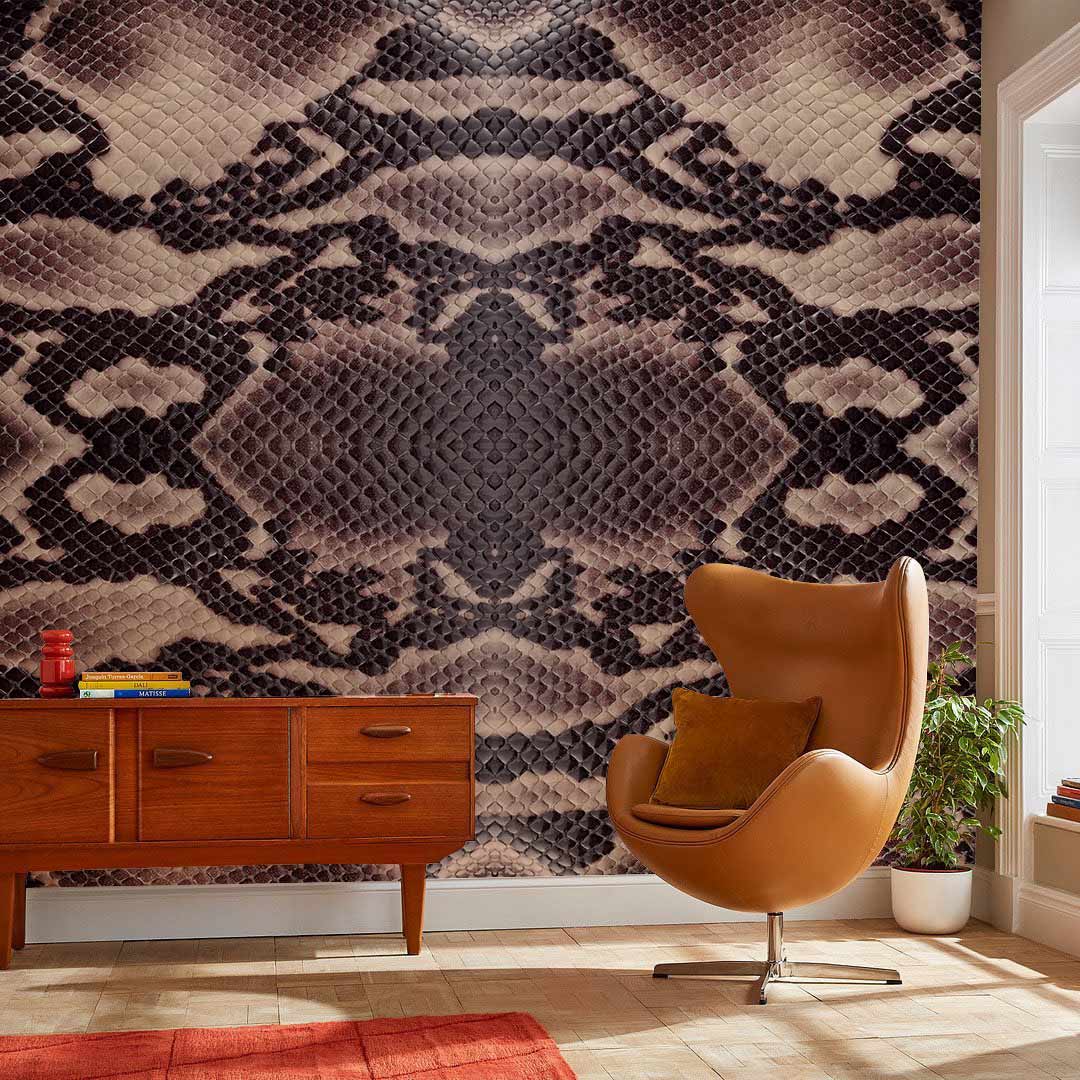 Exotic Brown Snake Skin Pattern Wallpaper in living room, featuring retro sideboard, swivel chair, wooden flooring.