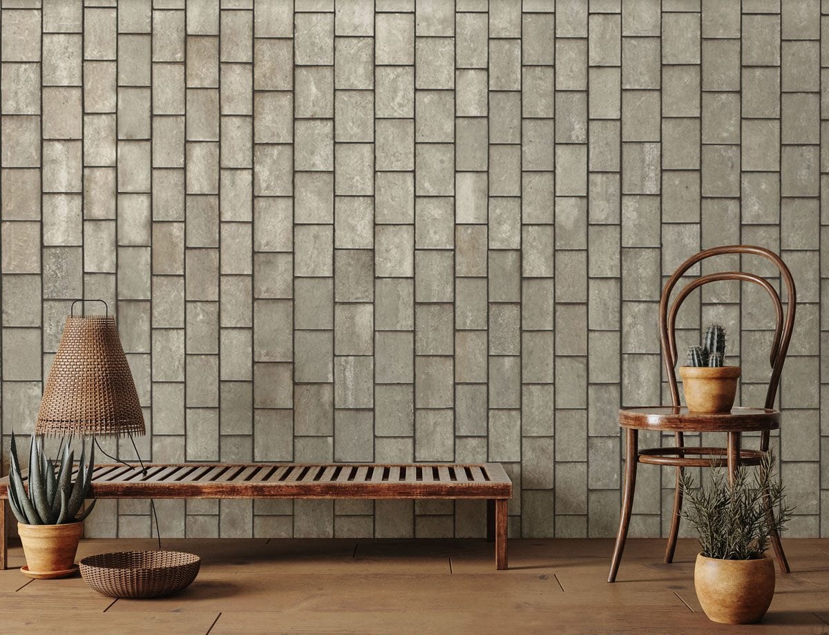 Rustic grey brick pattern wallpaper, vintage stone effect; wooden chair, bench, brown wooden flooring.
