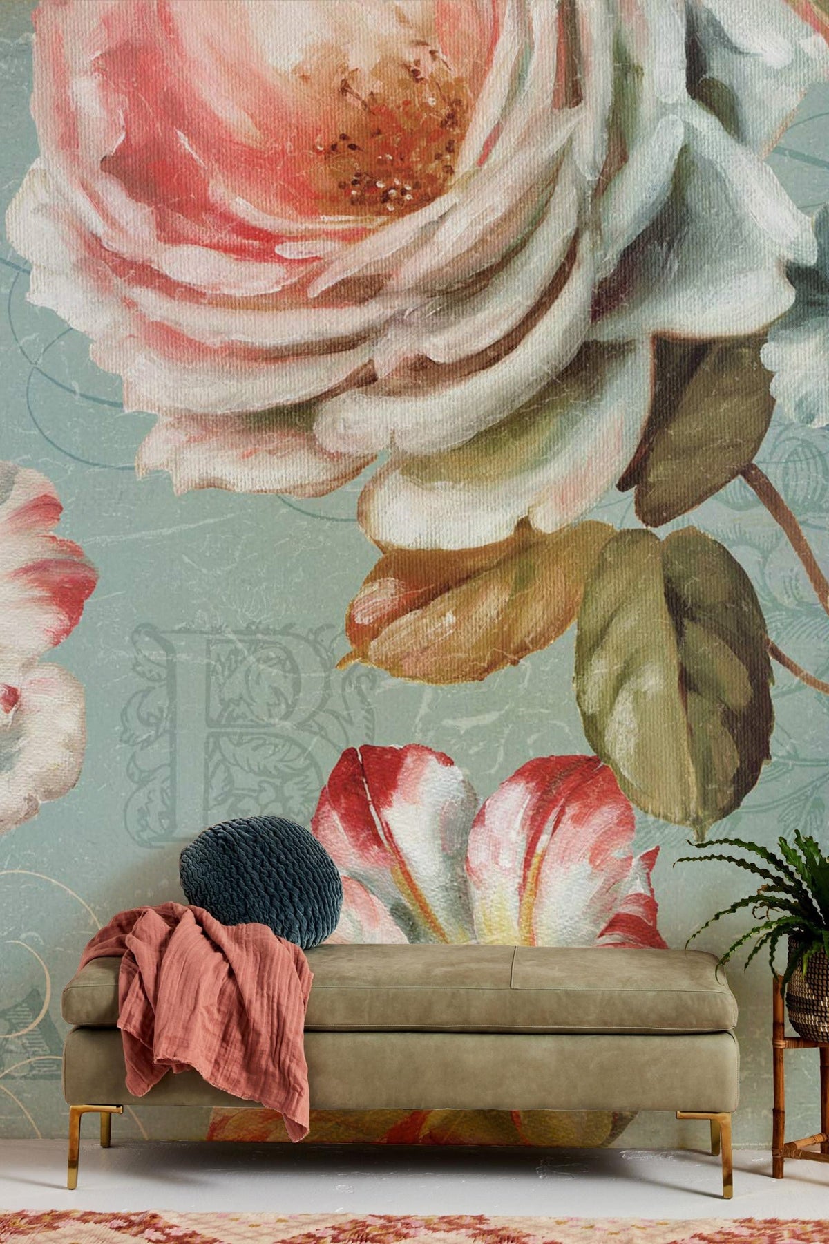 Vintage floral mural wallpaper with roses; green sofa; textured blue background; elegant living room decor.