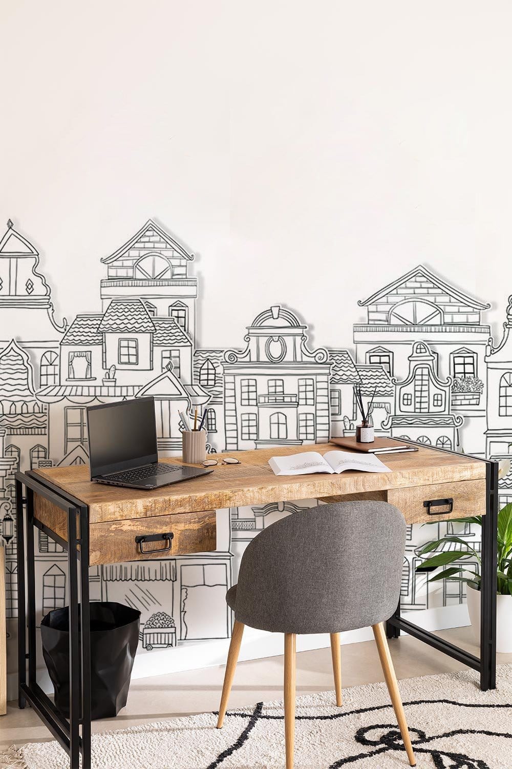 Home office with Vintage Monochrome Cityscape Mural Wallpaper, rustic desk, grey chair, cream rug.