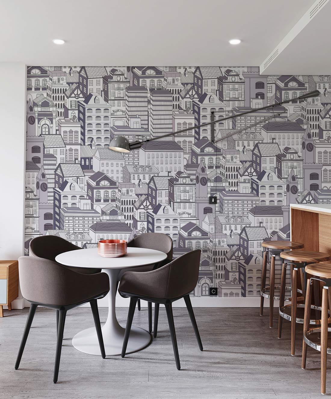 Monochrome urban cityscape wallpaper in kitchen, round table, grey chairs, wood flooring, contemporary decor.