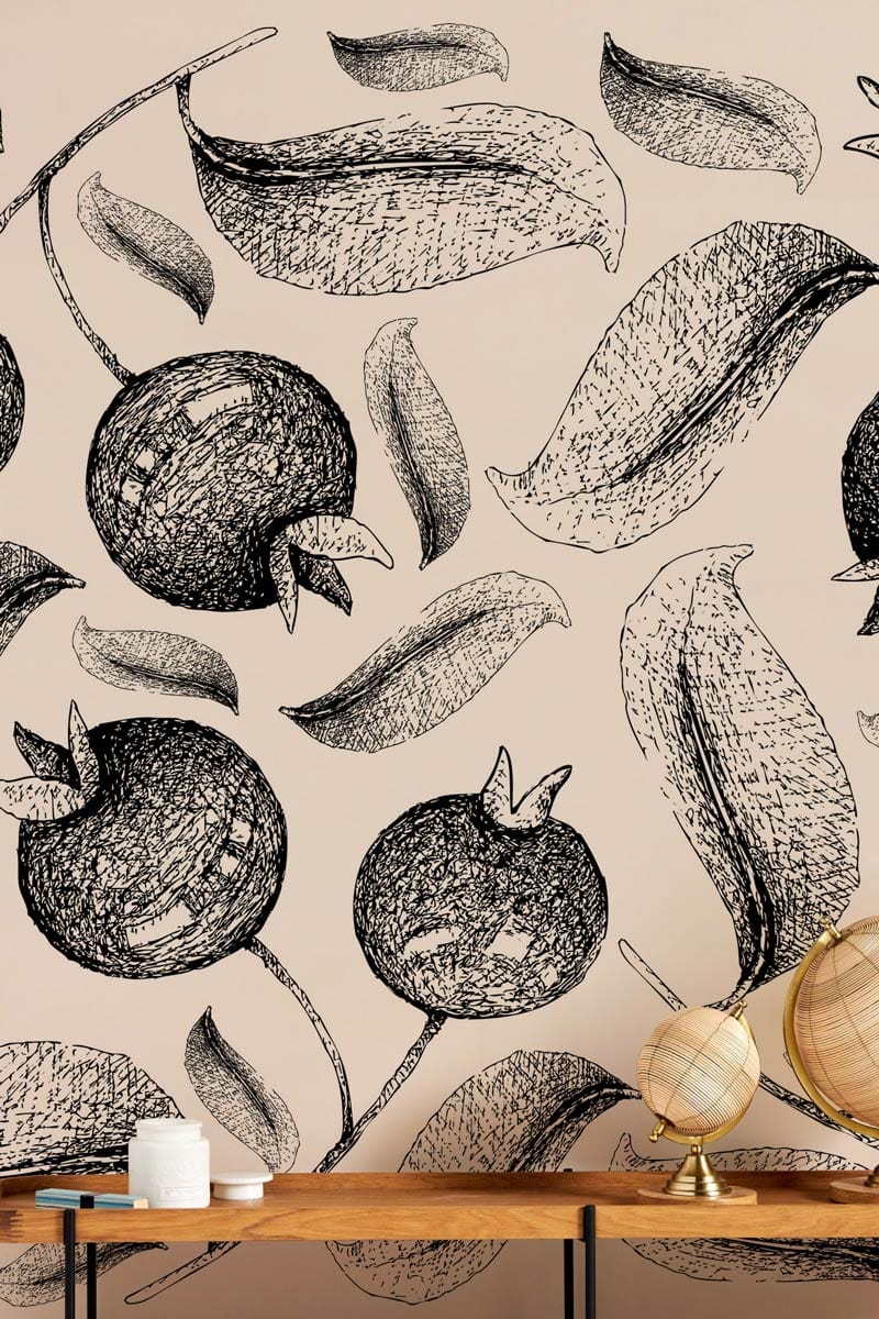 Monochrome pomegranate sketch wallpaper in modern interior with wooden table and decorative globes.