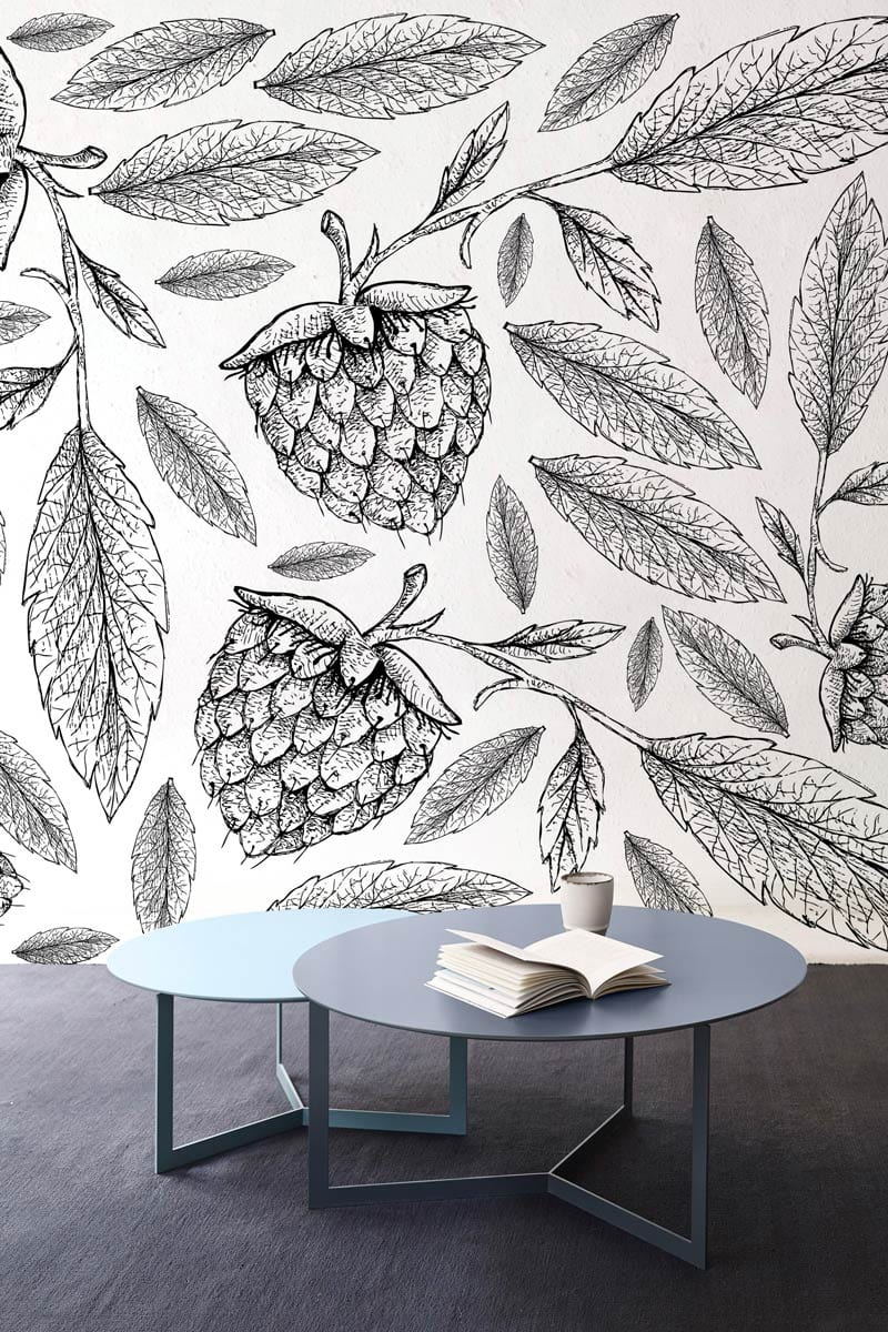 Monochrome botanical berry wallpaper with round tables, dark flooring, ideal for elegant living rooms.