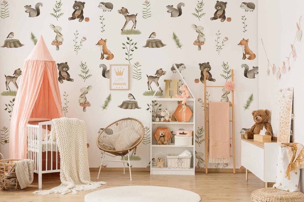 Charming nursery wallpaper with pastel woodland creatures, wicker furniture, pink canopy, and wooden flooring.