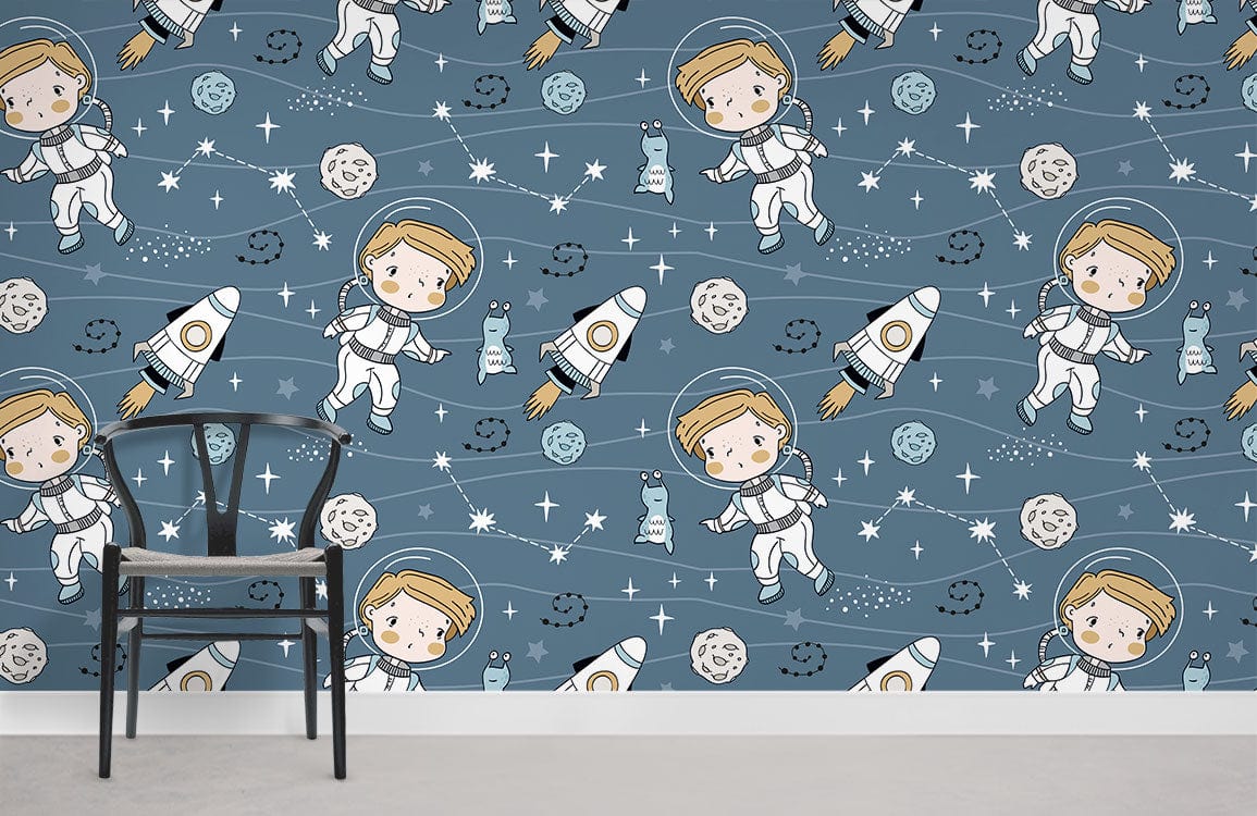 Blue astronaut wallpaper for kids' room with chair, grey floor, outer space theme.