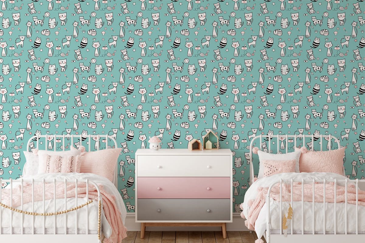 Whimsical cat pattern turquoise wallpaper in children's room, with white beds and pastel dresser.