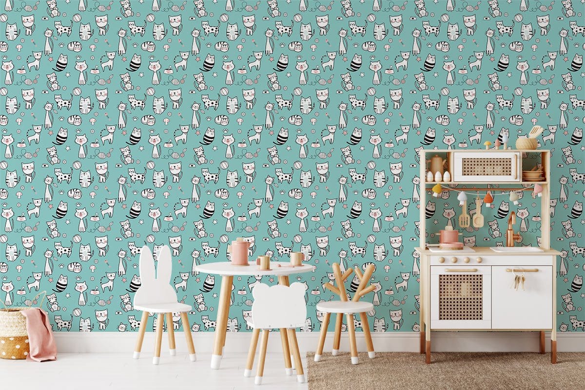 Playful turquoise wallpaper with whimsical cat pattern in children's room, featuring a white play kitchen.