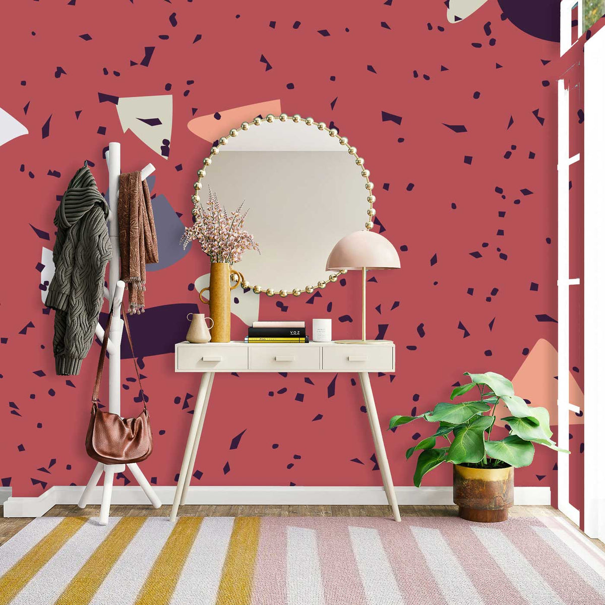 Retro geometric terracotta wallpaper decor, stylish console table, mirror, plant, and striped floor rug.