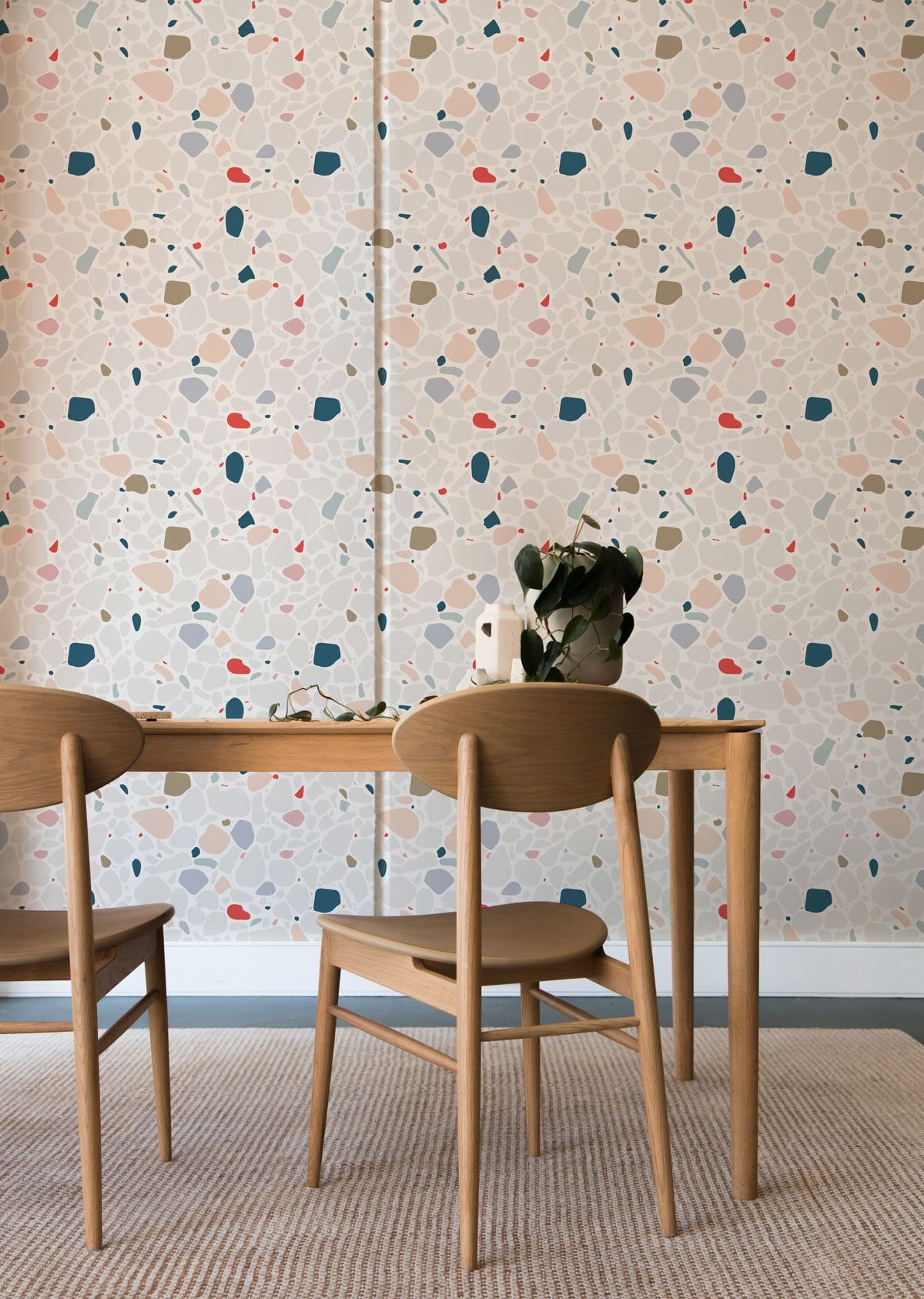 Charming multicolour polka dot wallpaper, wooden chairs, table, modern interior dining room setting.