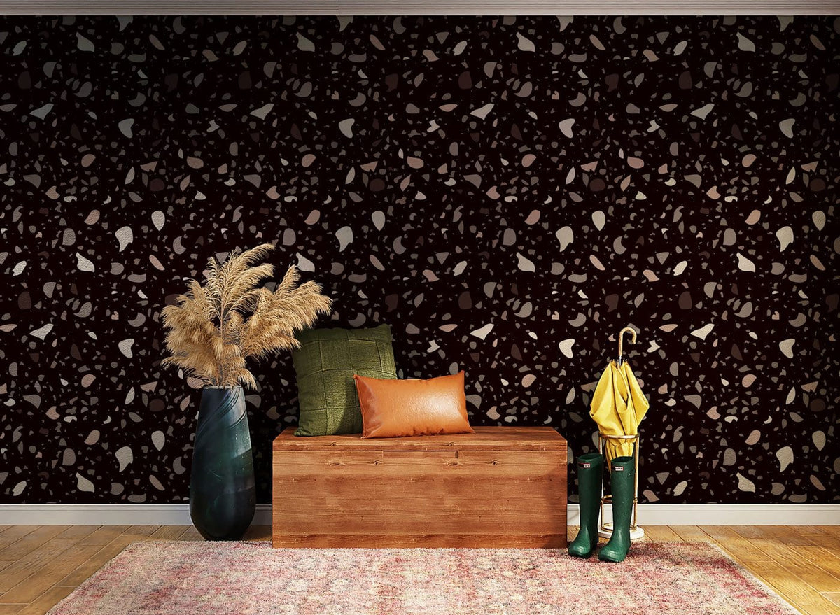 Brown and white terrazzo wallpaper with wooden bench, green cushion, leather pillow, and patterned rug.