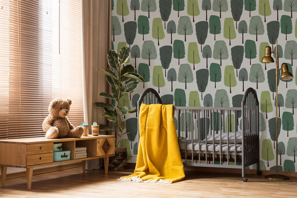 Green Scandinavian forest wallpaper in nursery, featuring wooden flooring, crib, and warm decor accents.