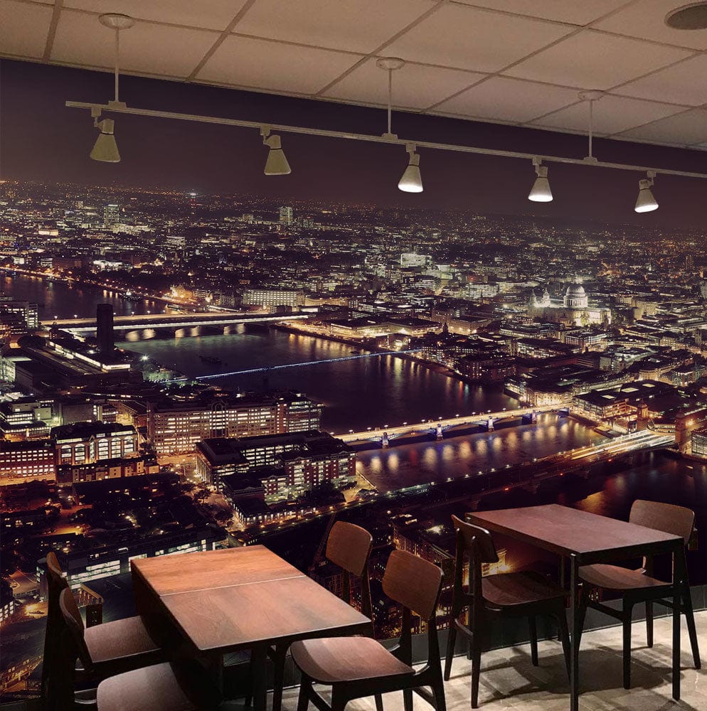 London Night Skyline Mural in café setting with wooden tables, dark chairs, and ceiling lights.