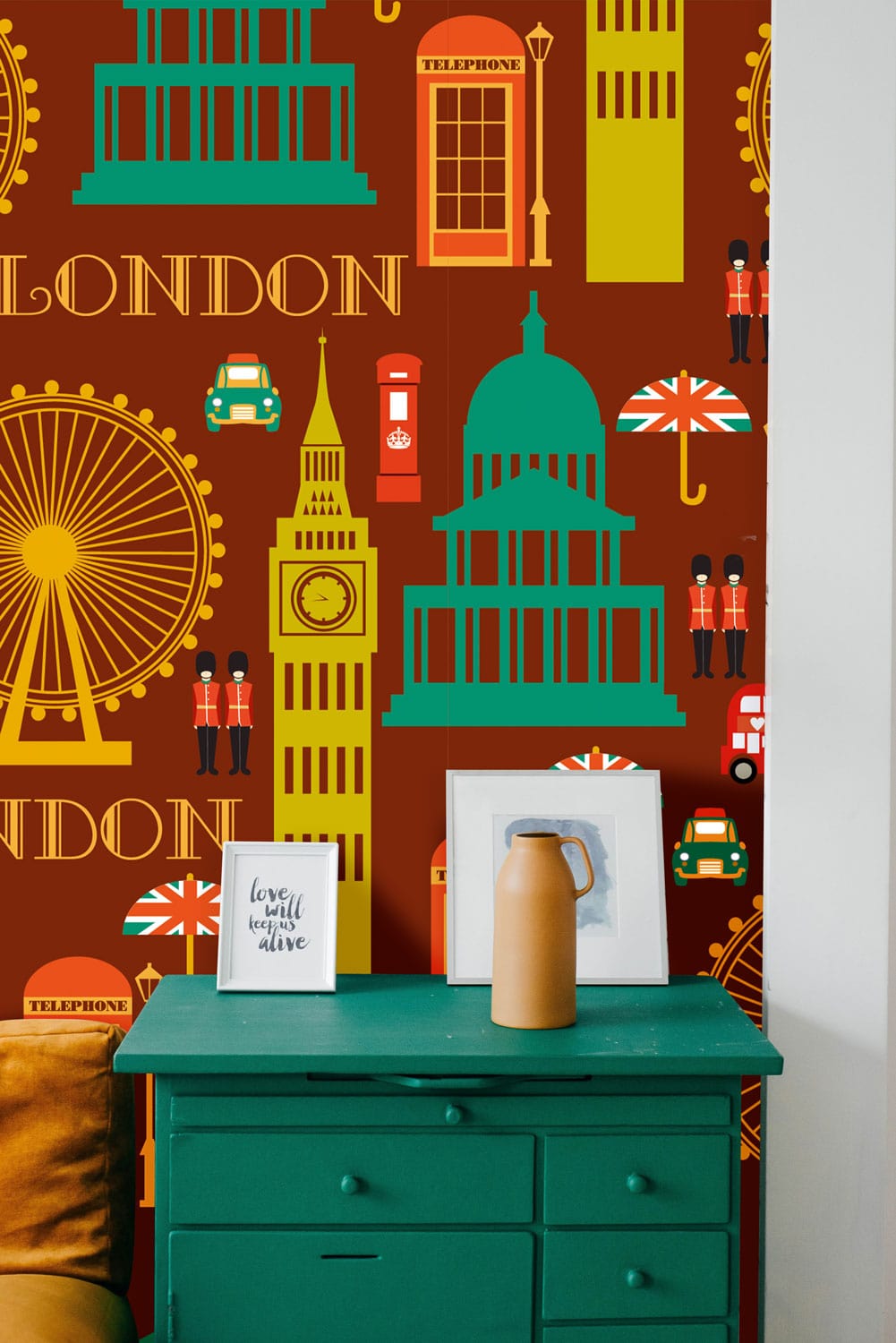 Vintage London landmarks patterned wallpaper, rich earthy tones, teal dresser, and a mustard sofa in view.