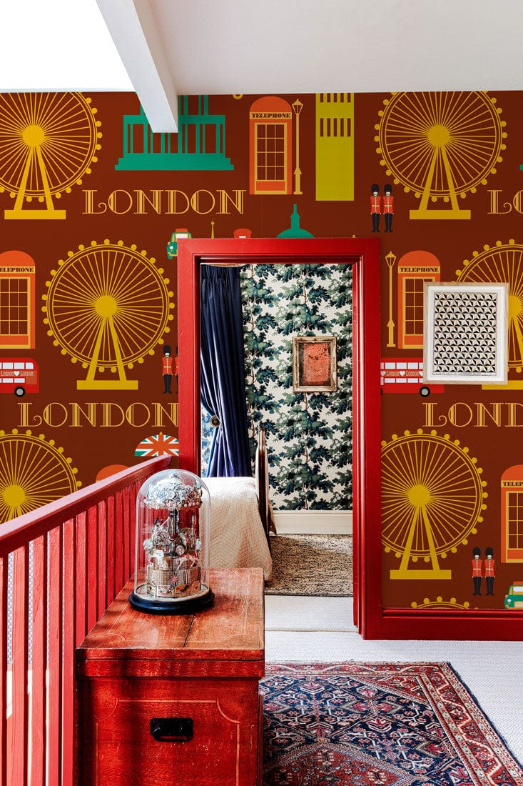 Vintage London wallpaper, red accents, patterned rug, hallway view, rich earthy tones, eclectic decor.