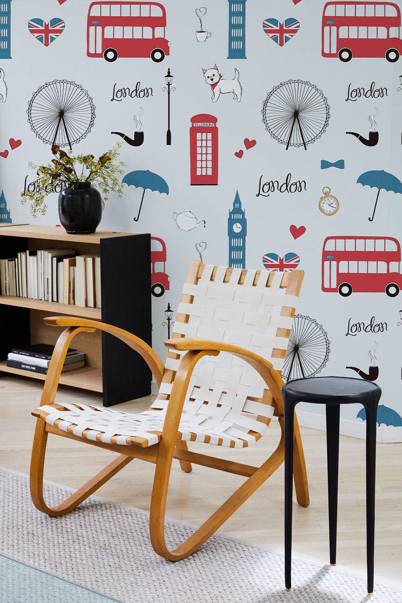 London-themed wallpaper, red-blue pattern, wooden armchair, light hardwood flooring, modern living room design.