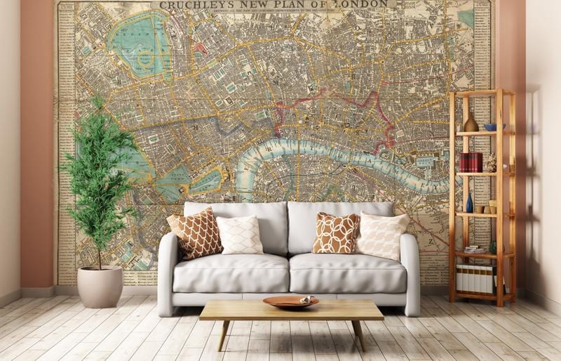 Vintage London map mural wallpaper, sepia tones, beige sofa, wooden flooring, living room setting.