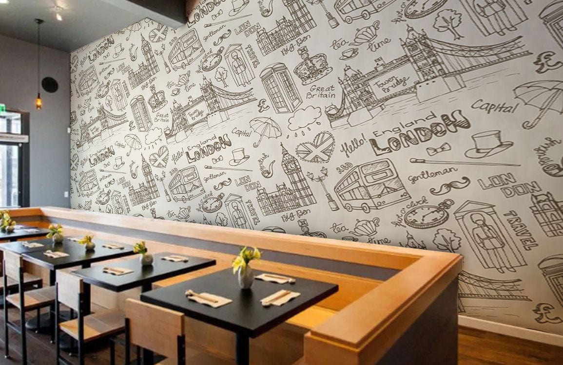 Cafe setting featuring beige monochrome British icon patterned wallpaper, modern tables, wooden flooring.
