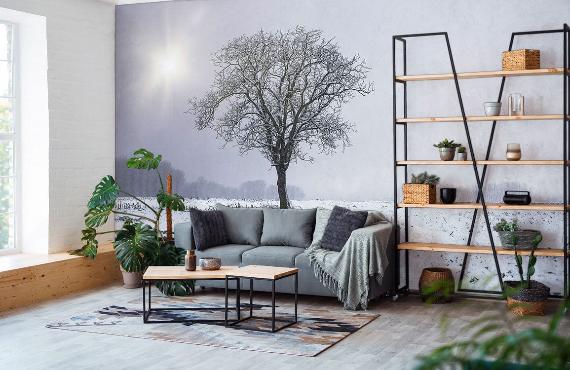 Winter Solitude Mural Wallpaper in living room with grey sofa, wooden flooring, and black shelving unit.