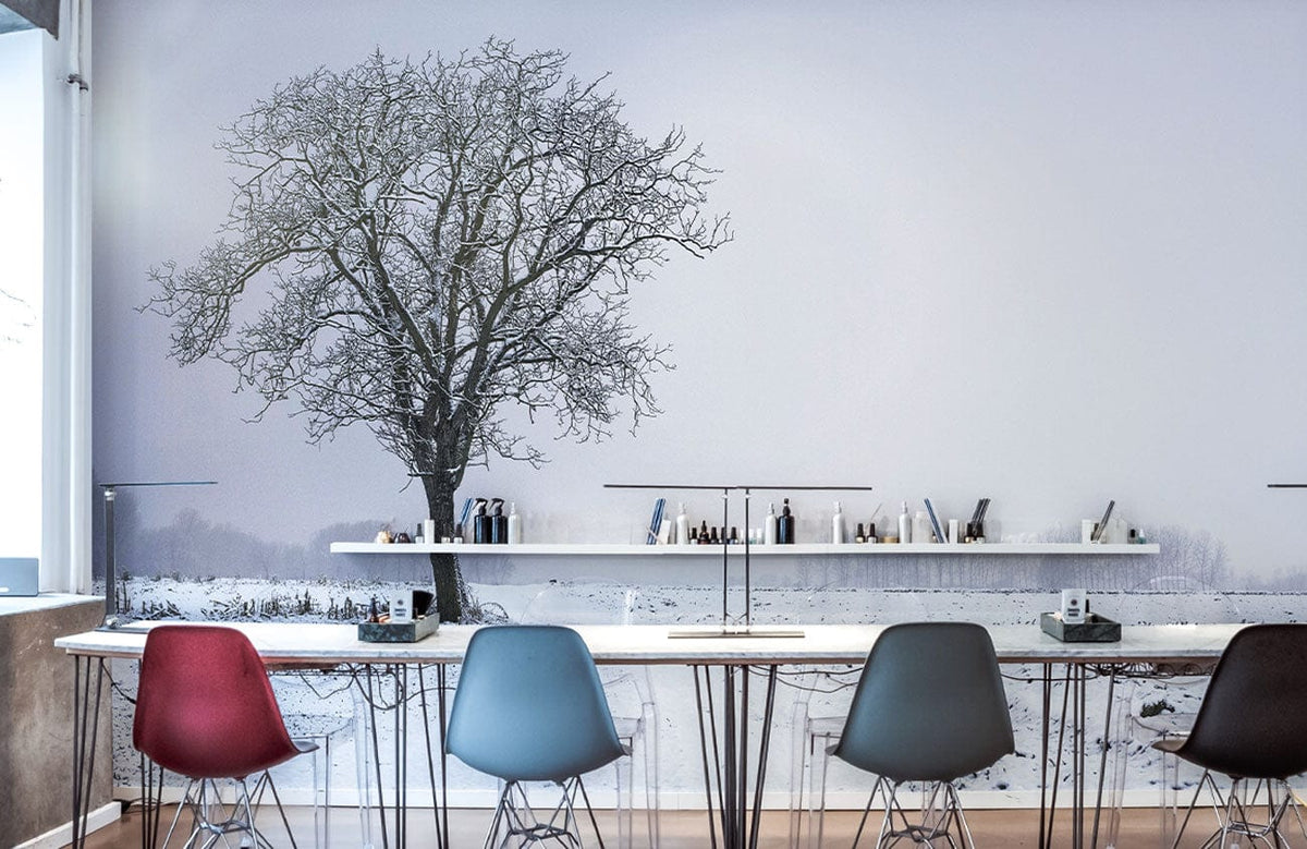 Winter Solitude Mural Wallpaper in office with colourful chairs, snowy landscape, bare tree, wooden flooring.