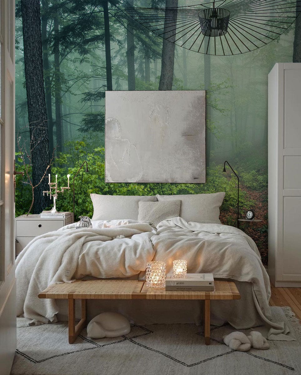 Mystical misty forest mural wallpaper in serene bedroom with cosy bed and natural wood accents.