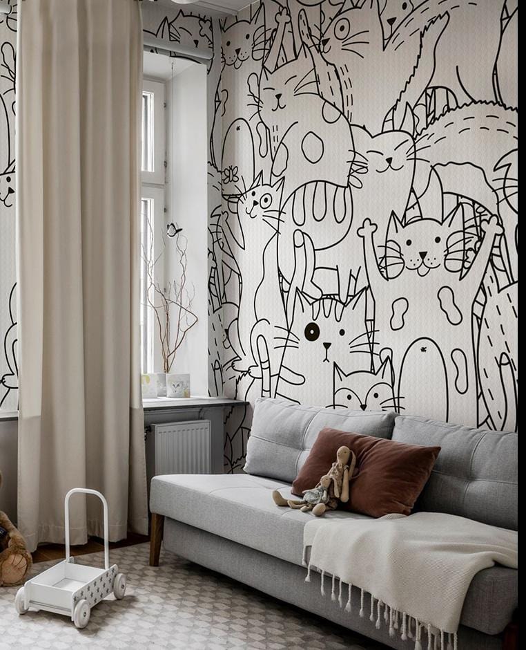 Monochrome cat wallpaper, whimsical design, grey sofa, white curtains, cosy children's room decor.