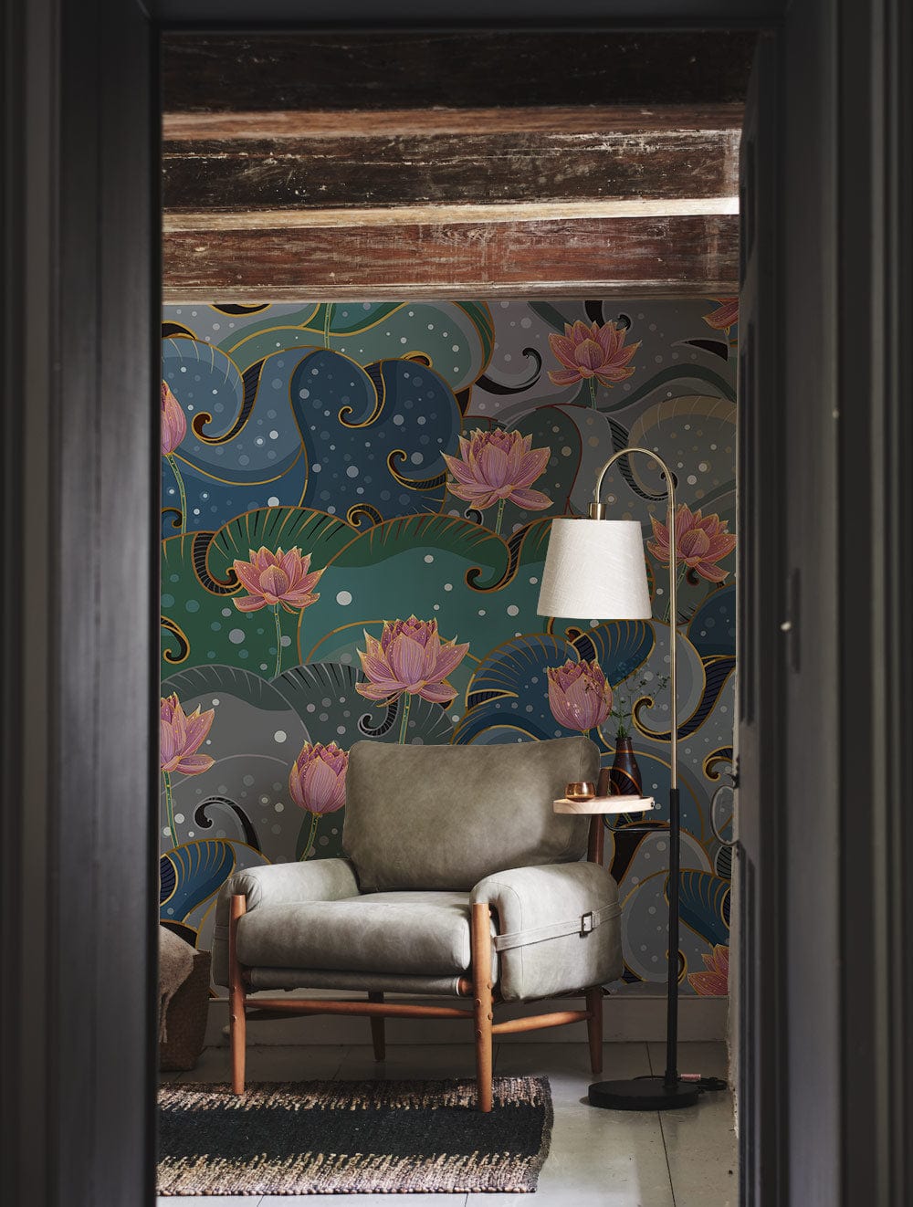 Elegant Lotus Blossom mural wallpaper, grey armchair, floor lamp, wooden beams, cosy living room setting.