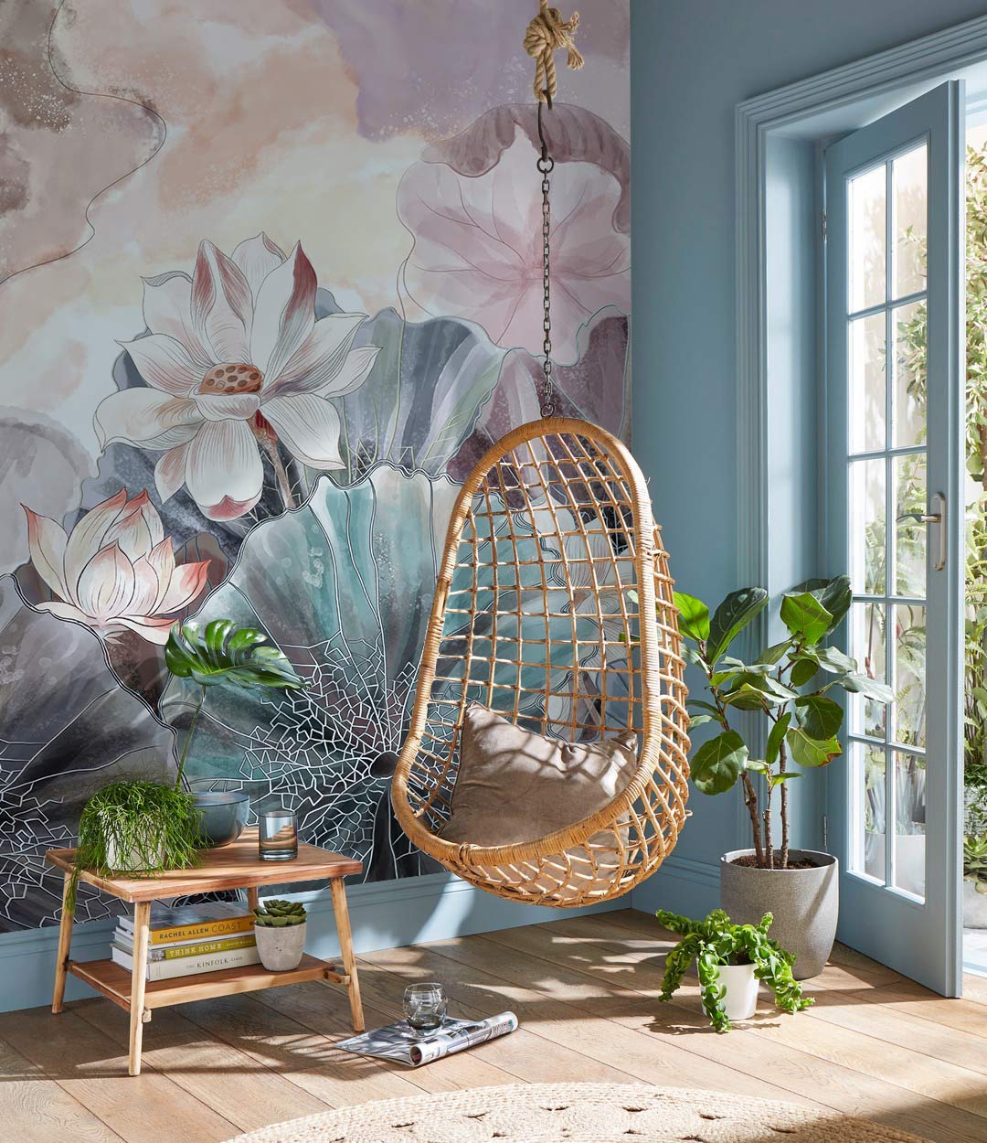 Pastel Dream Lotus Blossom Mural Wallpaper featuring wicker chair, hardwood flooring, and light blue walls.