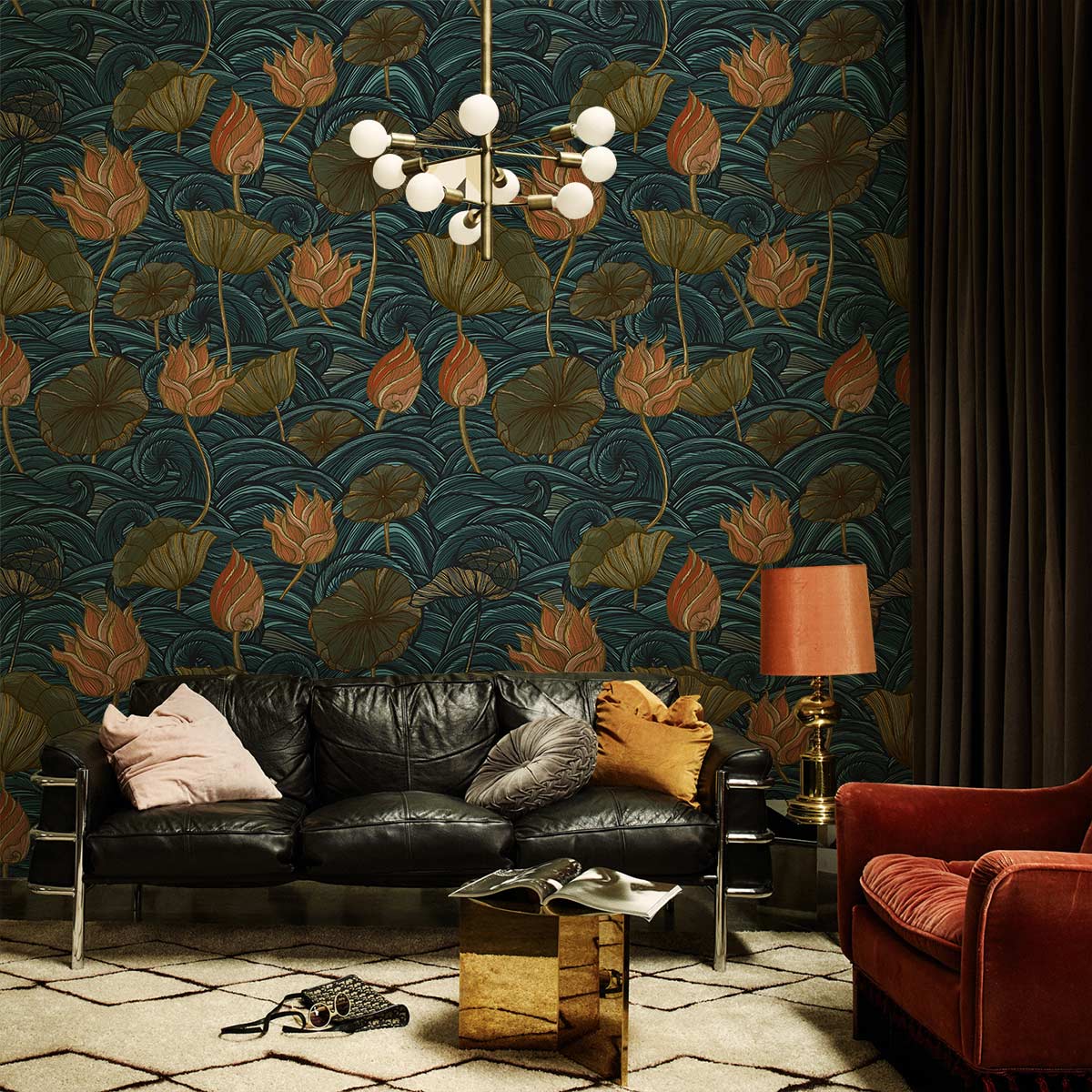 Vintage floral wallpaper in blue, orange hues; velvet sofa, geometric rug, modern chandelier, elegant room.