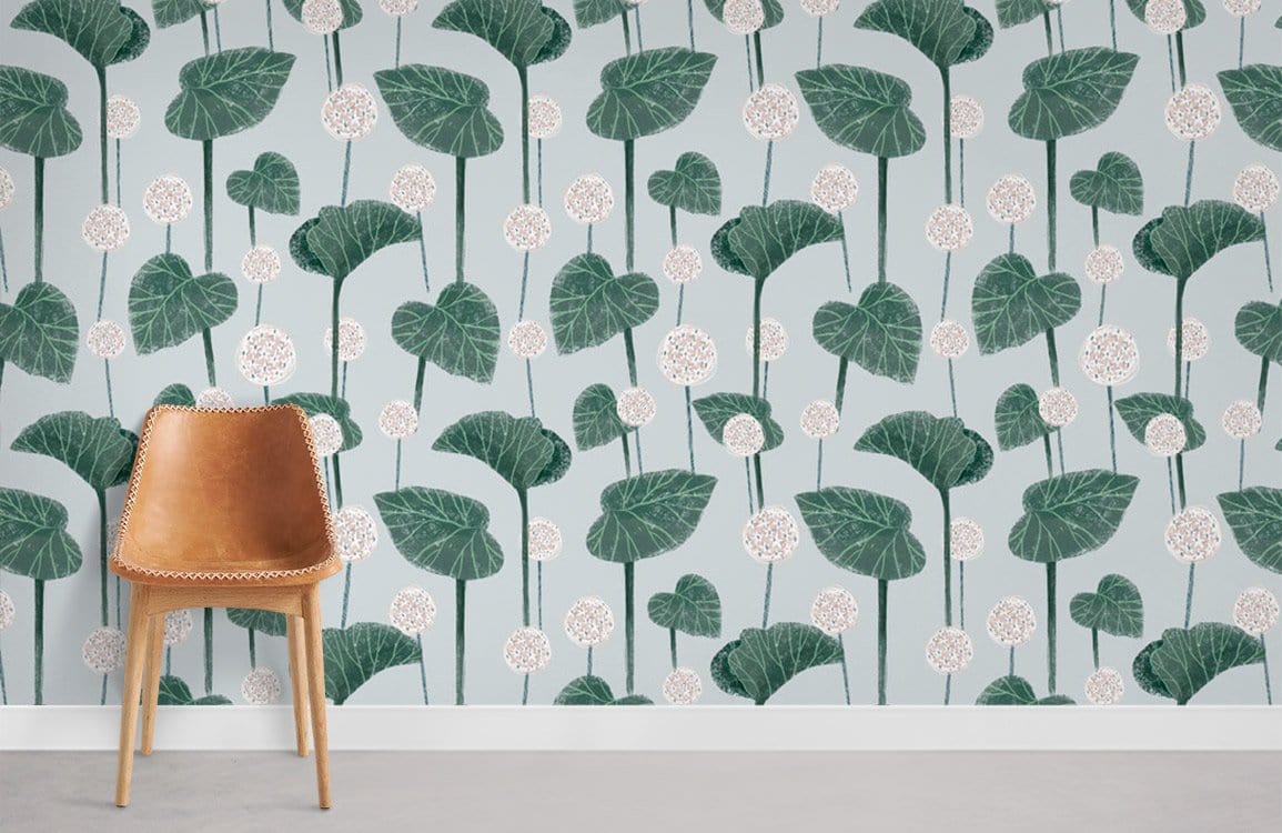 Elegant green botanical leaf wallpaper in living room with brown mid-century modern chair and grey flooring.