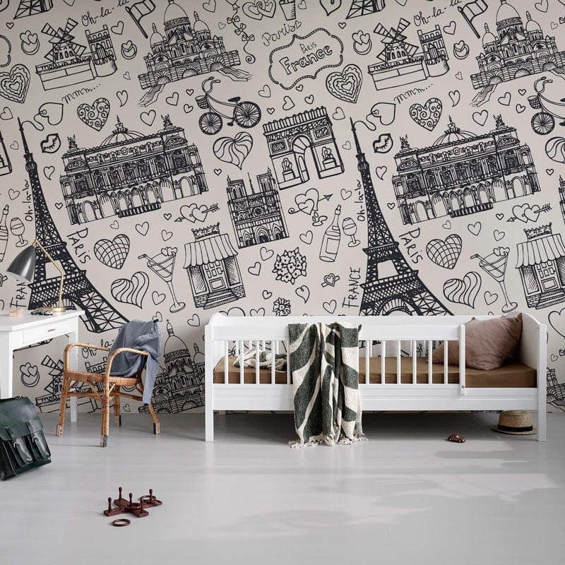 Parisian Sketch wallpaper in children's room with white furniture, grey flooring, and illustrated pattern design.
