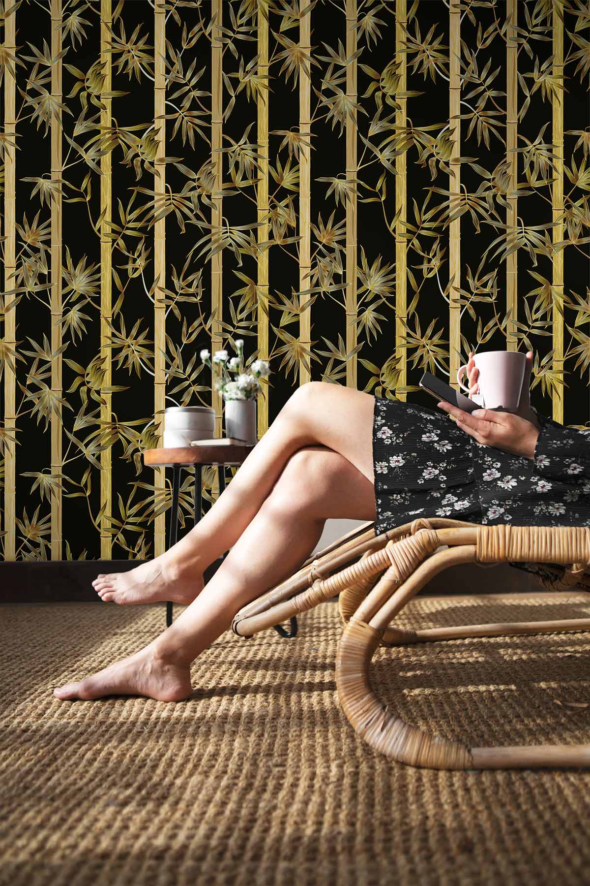 Luxurious black and gold bamboo wallpaper with wicker chair, natural fibre rug in cosy room setting.