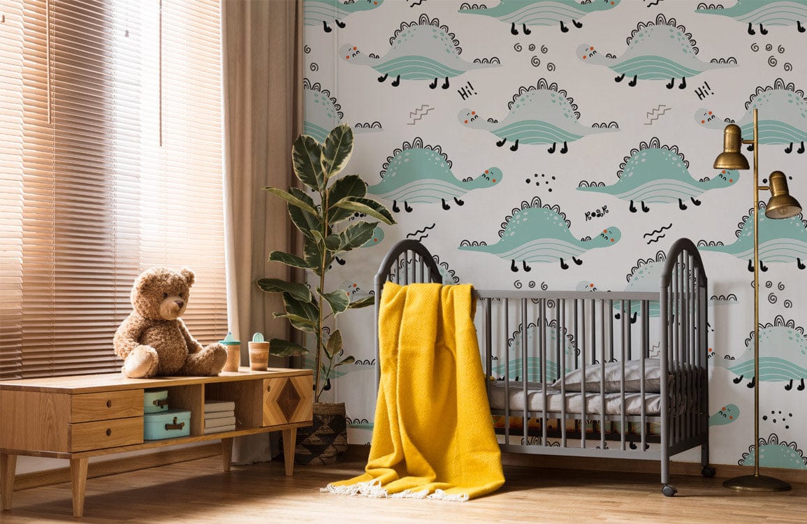 Child's room with playful dinosaur wallpaper in pastel green, crib, wooden sideboard, and leafy plant.