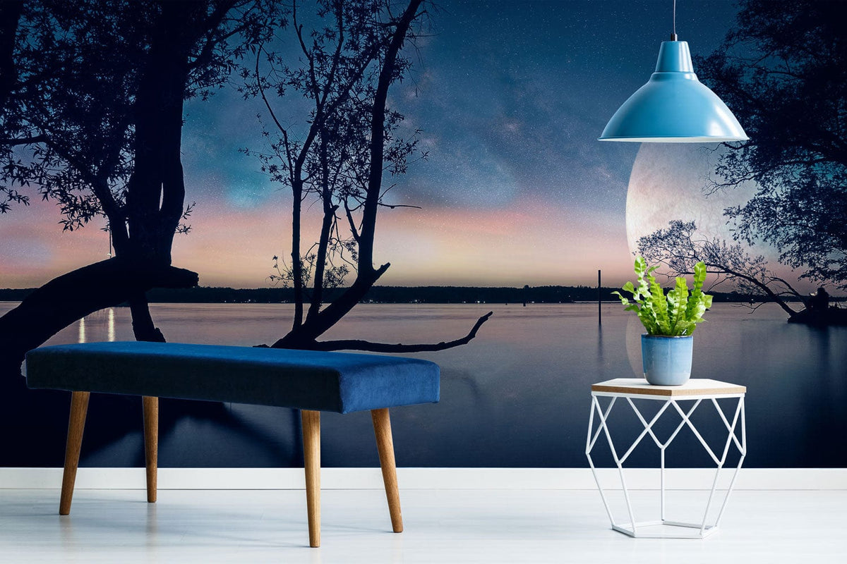 Tranquil Twilight Lagoon mural wallpaper, modern blue bench, pendant light; serene living room setting.