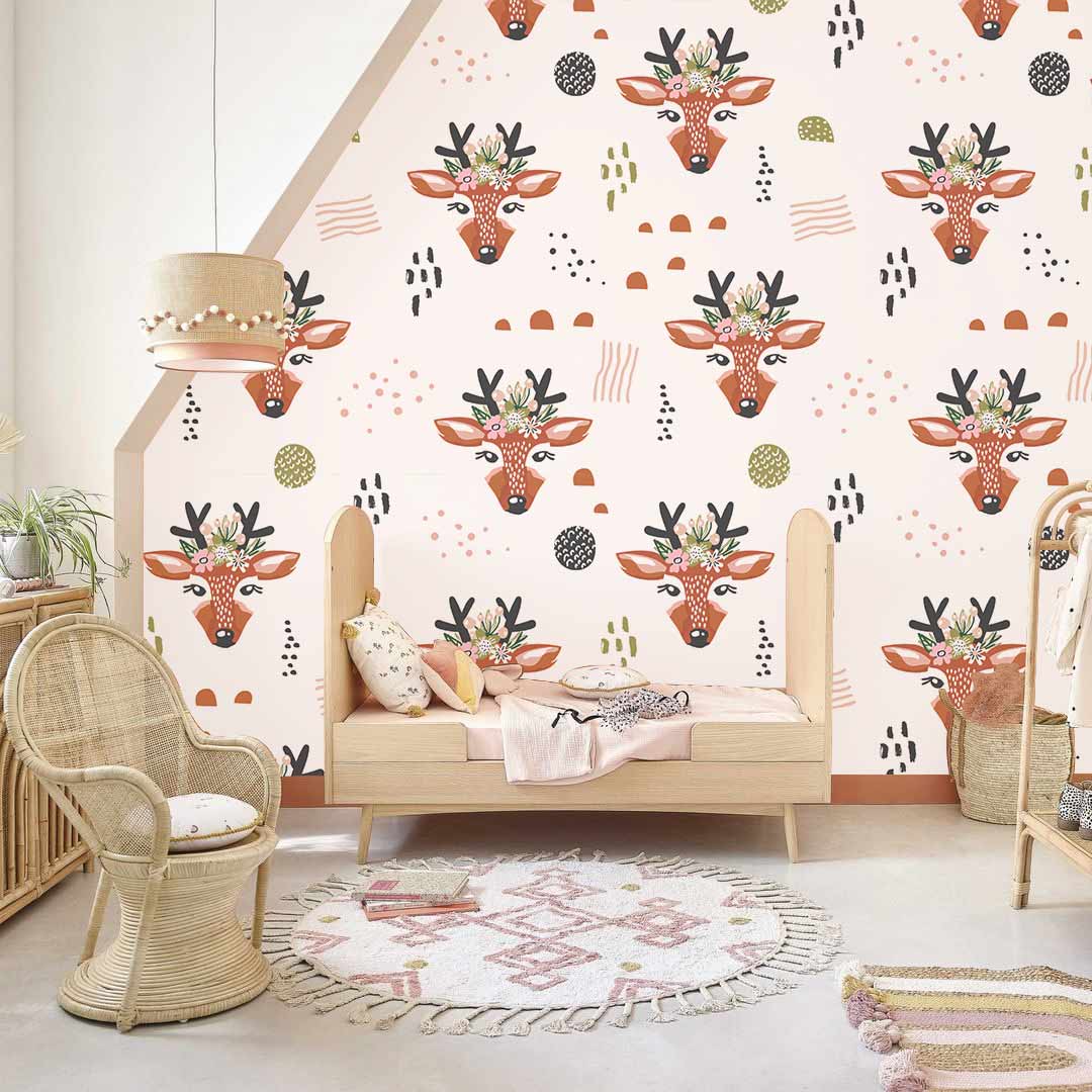 Whimsical deer wallpaper in earthy tones, rattan chair, wooden bench, nursery room, geometric rug.