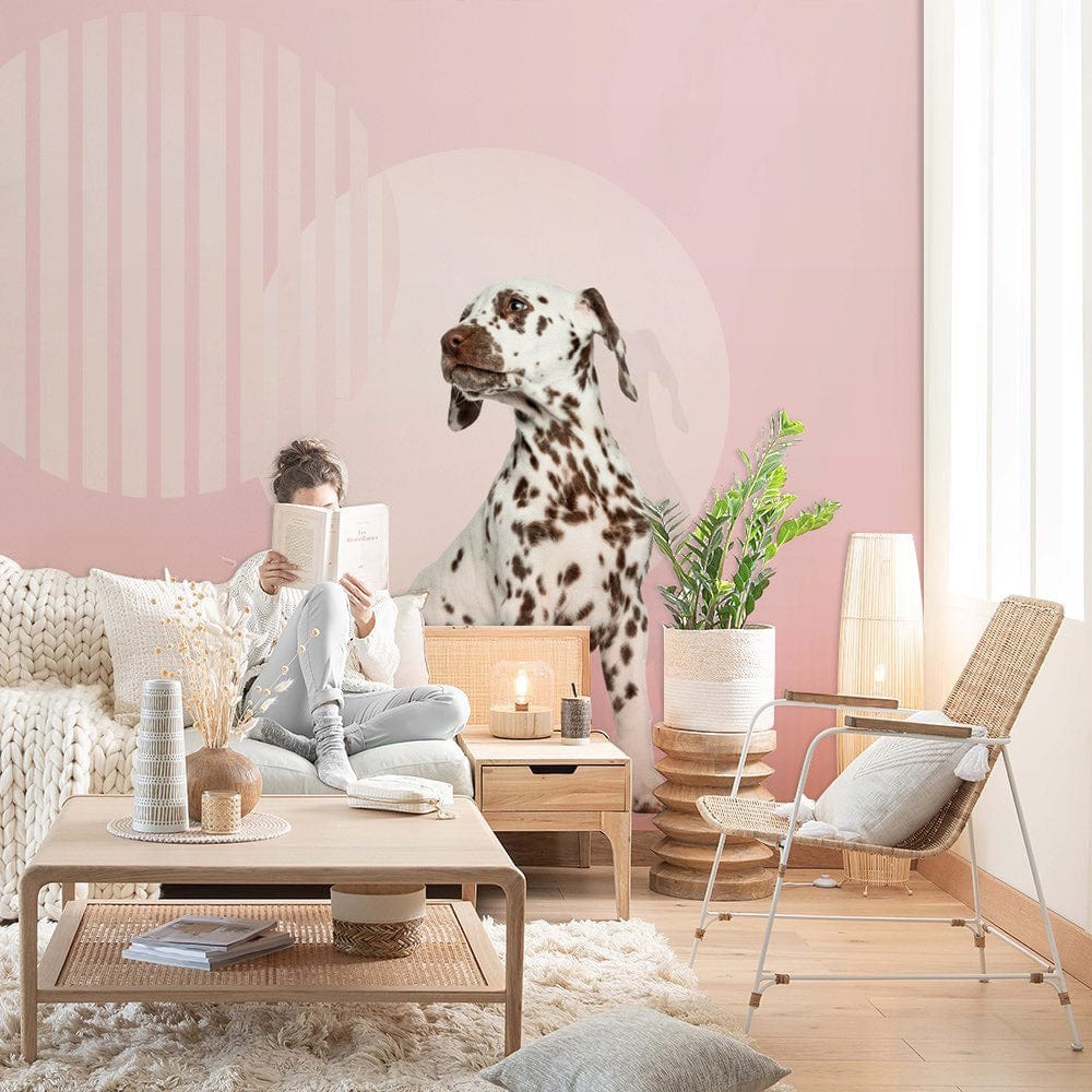 Modern lounge with pastel pink abstract circles wallpaper, cosy white sofa, wooden furniture, and plush rug.