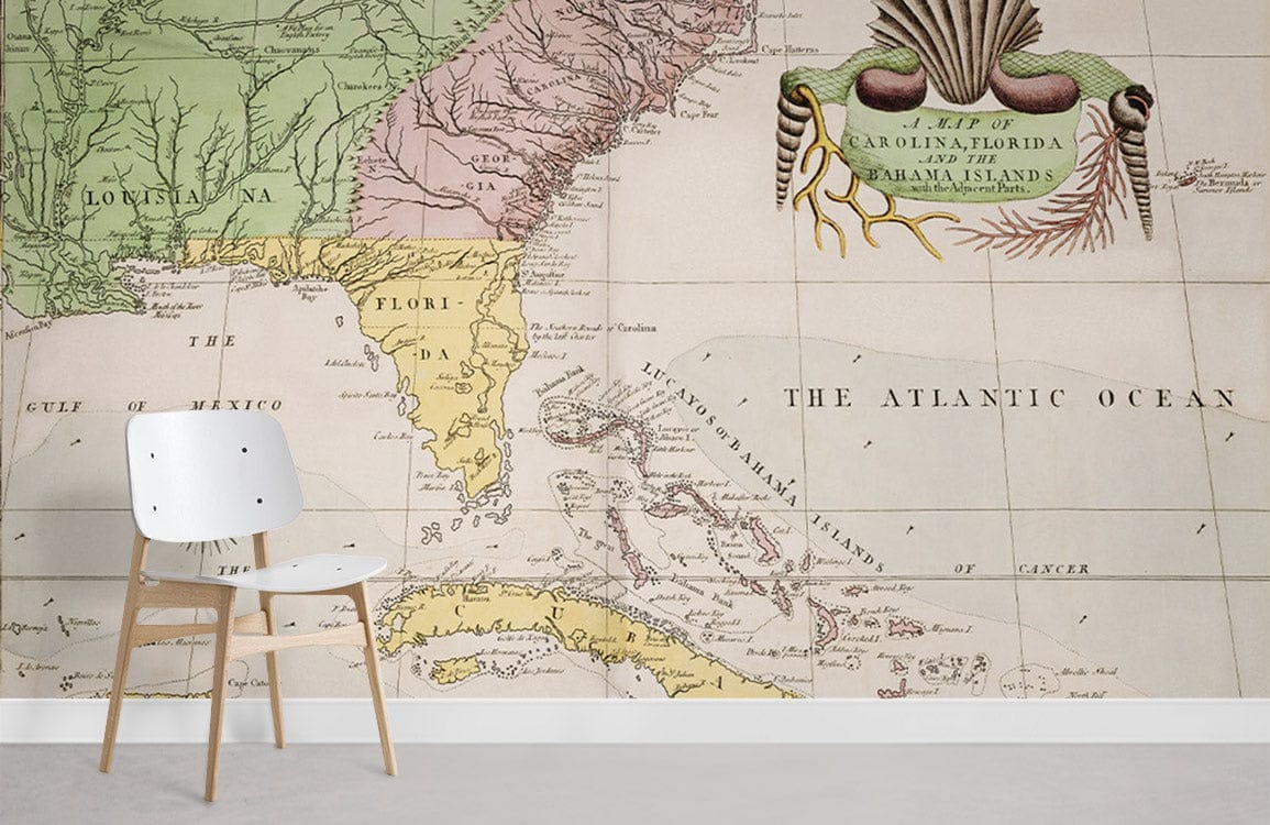 Vintage Caribbean map mural wallpaper, muted pastels, modern white chair, grey floor in bright room.