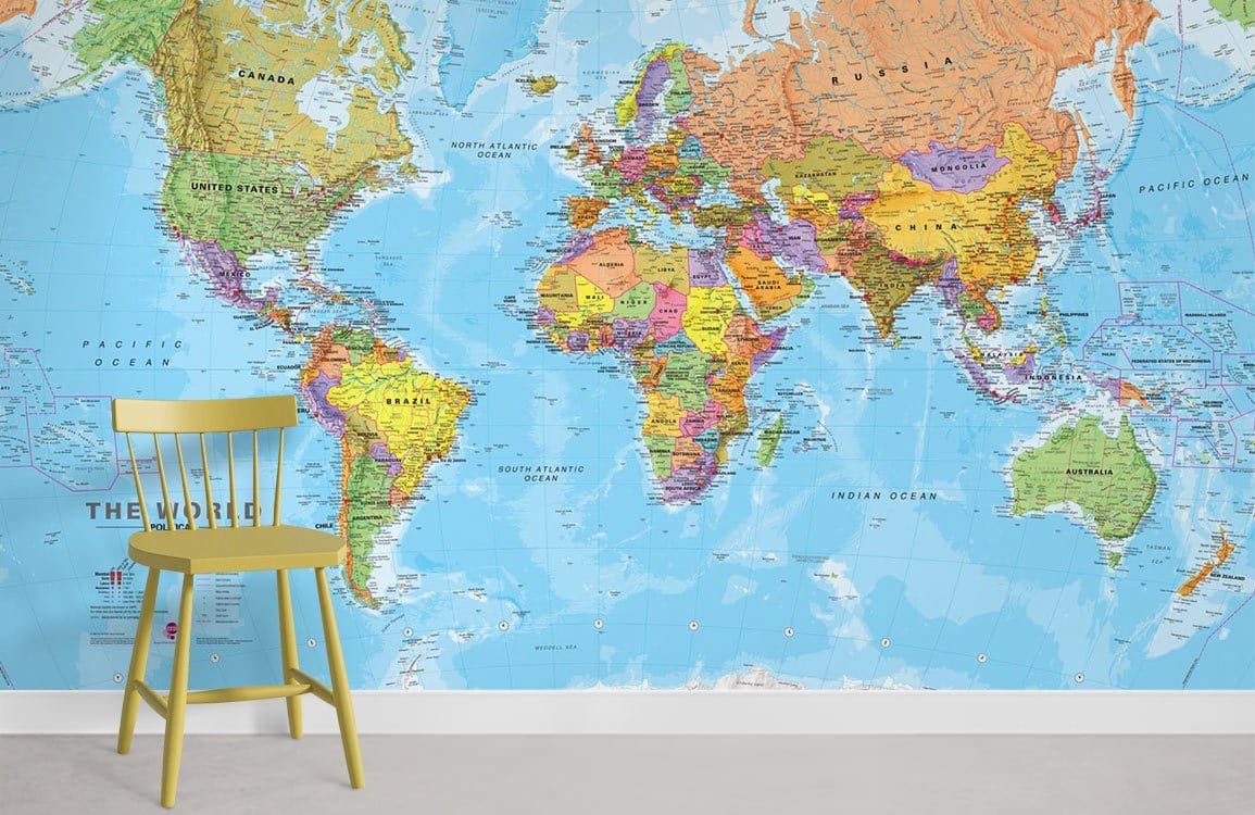 Vibrant World Map Mural Wallpaper in blue with yellow chair, grey floor in modern room setting.